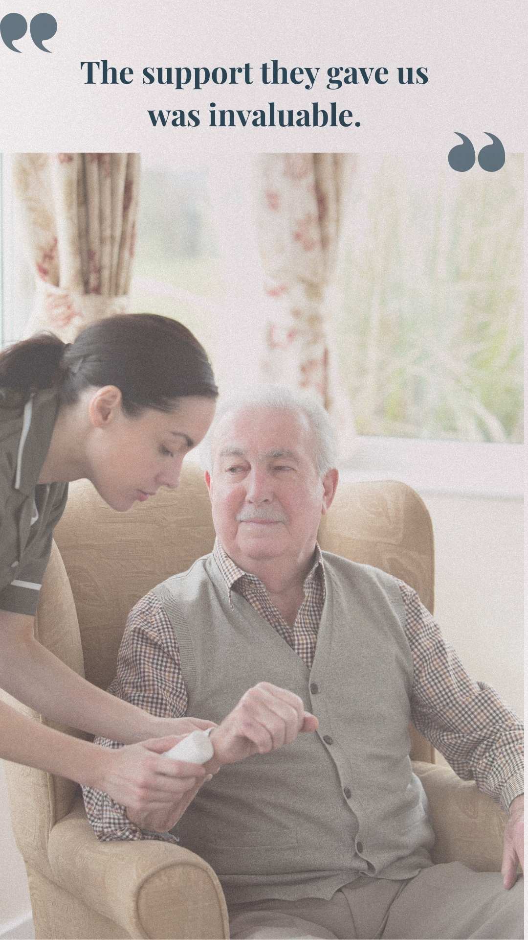Caregiver assisting an elderly man seated in an armchair in a bright, homely setting.
